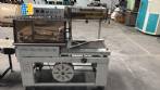 Automatic L-sealer with shrink tunnel.