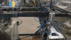 Pick and place product feeder for flowpack transfer cartoning machine