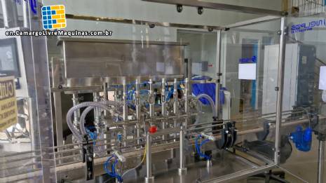 Complete filling line with Tecman Nelpas Tecnoenvase Tudela bottle filling, labeling, capping, and positioning machines for cosmetic liquids.