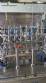 Complete filling line with Tecman Nelpas Tecnoenvase Tudela bottle filling, labeling, capping, and positioning machines for cosmetic liquids.