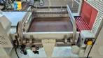 L-shaped packaging sealer with semi-automatic shrink tunnel.