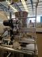 Vertical wrapping machine for triangular format