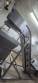 Inova Industrial inclined stainless steel conveyor belt with cleats.
