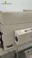 Label applicator machine with steam-operated shrink tunnel for sleeves.
