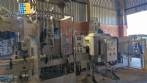 Labeling machine with steam sleeve tunnel and bottle baler