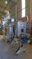 Labeling machine with steam sleeve tunnel and bottle baler