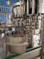 Zegla rotary filling machine with rinser and three-block capping system.