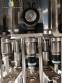 Zegla rotary filling machine with rinser and three-block capping system.