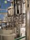 Zegla rotary filling machine with rinser and three-block capping system.