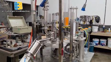 Rotary filling and dosing machine with capping and sealing unit for cups and bottles, capacity 2,000 units. Rotary filling and dosing machine with capping and sealing unit for cups and bottles, capacity 2,000 units.